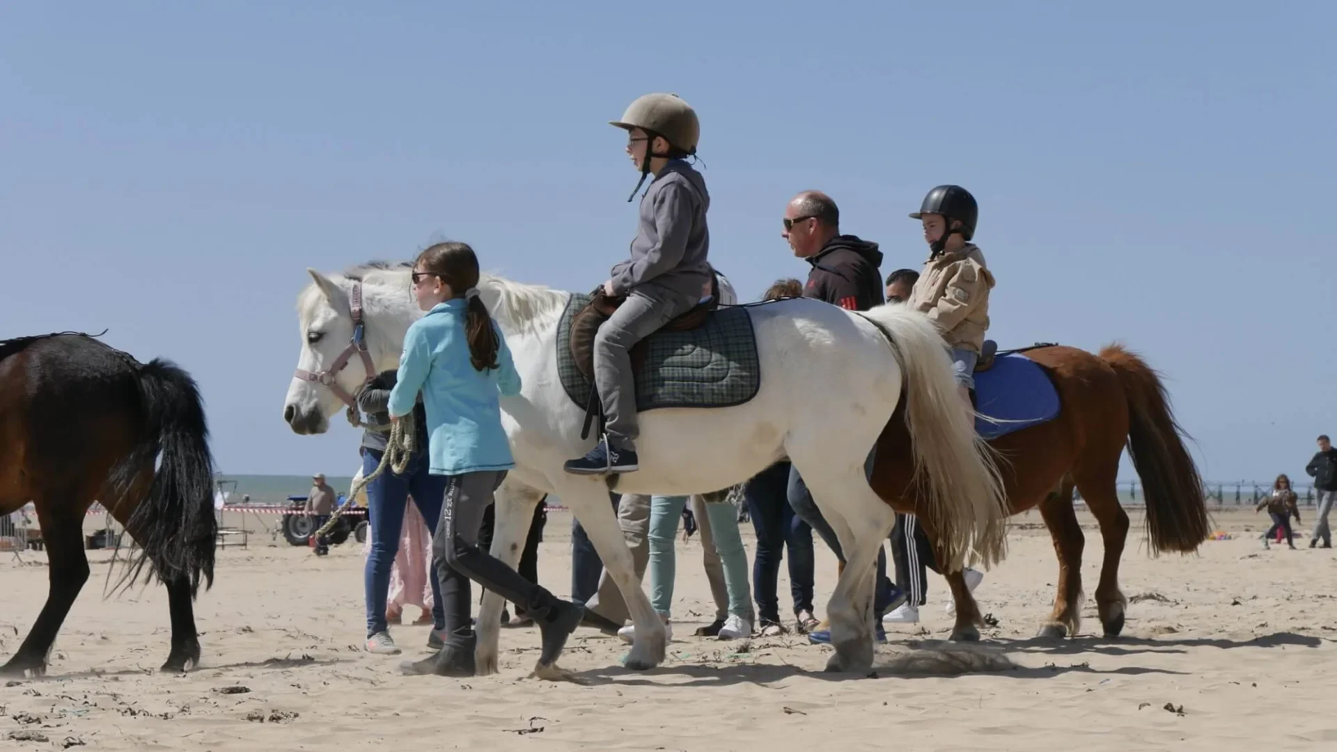 Photo de plusieurs enfants à cheval en balade sur la plage lors de l'évènement Caval Océane à Saint Jean de Monts