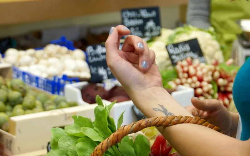 Someone buying fresh product in a market in Pays de Saint Jean de Monts